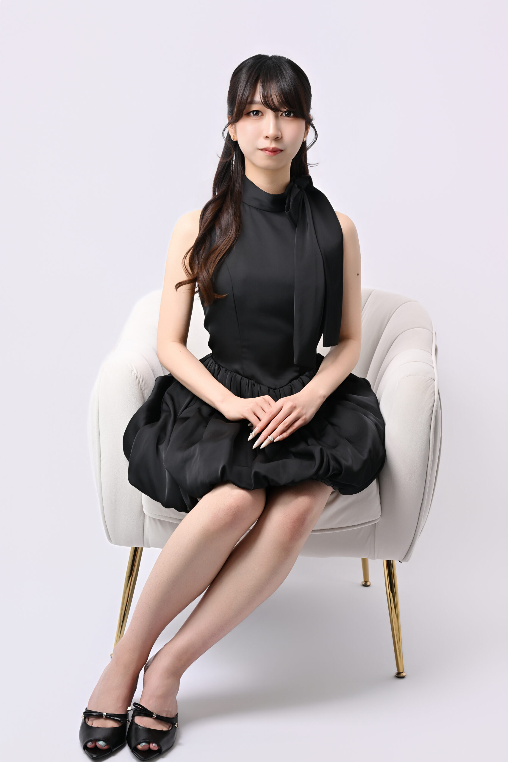 椅子に座った黒ドレスの落ち着いた宣材写真